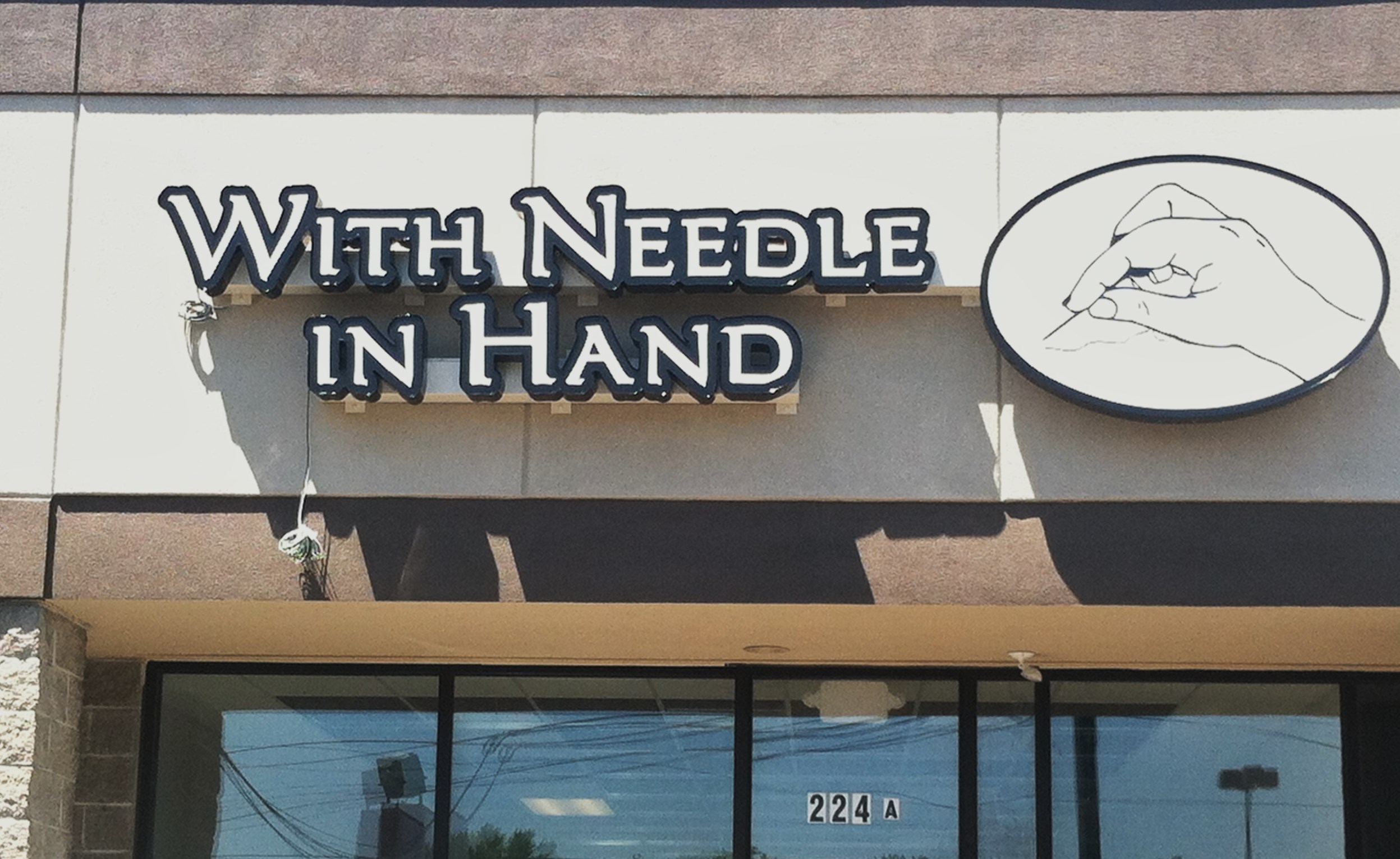 With Needle in 
Hand Store Front